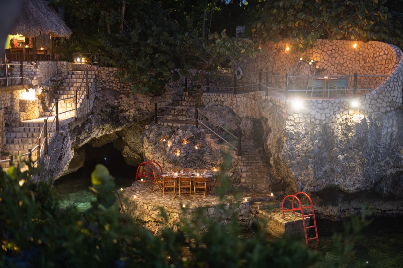 A candlelit table for two on the cliffs at Rockhouse at night
